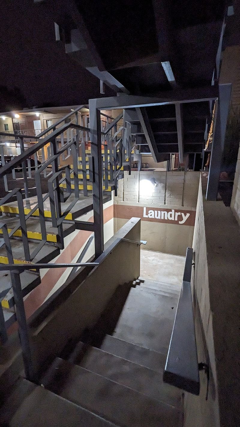 Exterior on-site laundry in the basement. Steps down - well lit at night (next to elevator just north of unit)