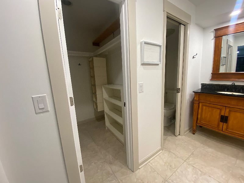Hall Full Bath with two vanities, shower, toilet, linen closet and walk in closet