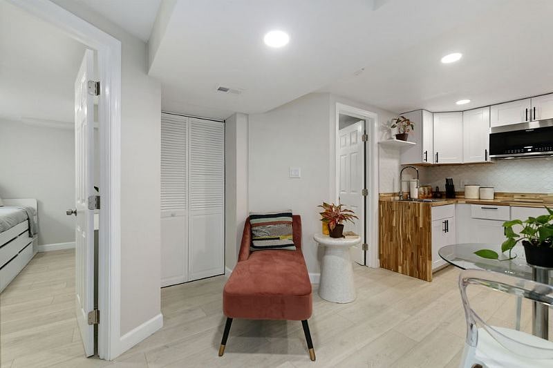 Basement living space. Full size washer and dryer behind doors