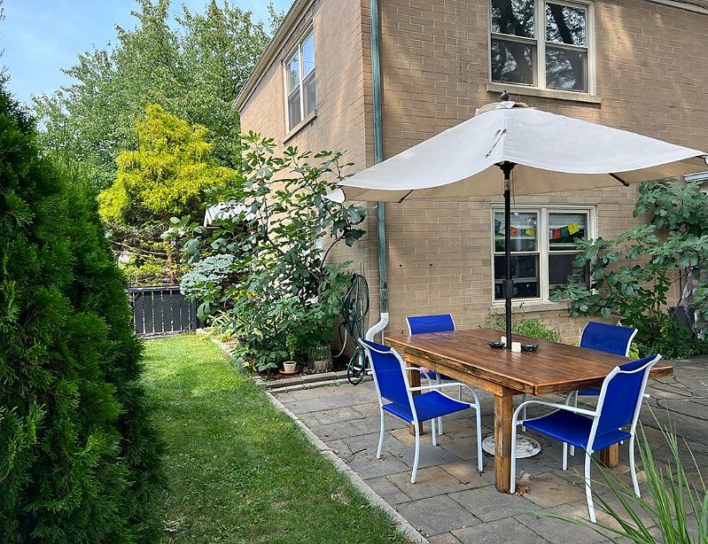 Accessible backyard with shared table on patio.