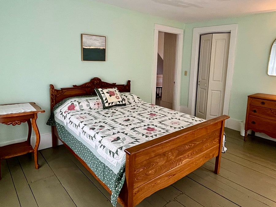 Bedroom with full size bed, carved oak frame.