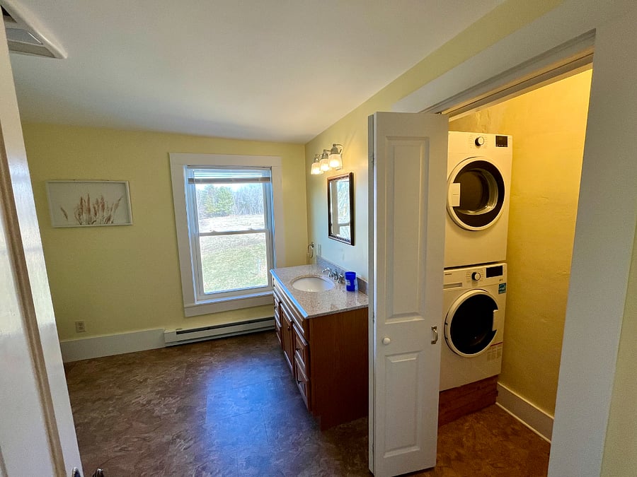 Bathroom with enclosed laundry.