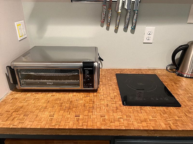 Ninja fast countertop oven/air fryer! Super fast induction cooktop! Oven pivots to allow more counter space as needed.
