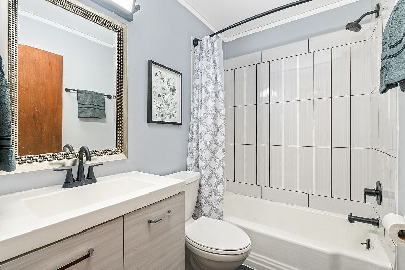 Freshly updated and modern bathroom with new tile, vanity and fixtures