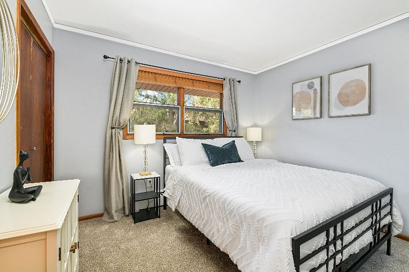 Bedroom 1 - queen bed with luxury linens, large closet, blinds plus room darkening curtains on windows, wall mounted smart TV