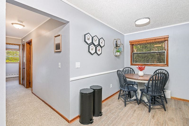 Open concept living room, dining area and kitchen that is open to hallway down to 2 bedrooms and bathroom