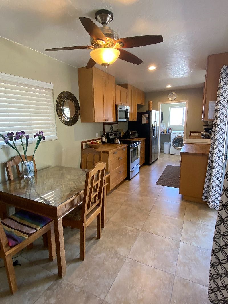 Coconut wood dinette next to kitchen .
Laundry room with Samsung washer and dryer.
