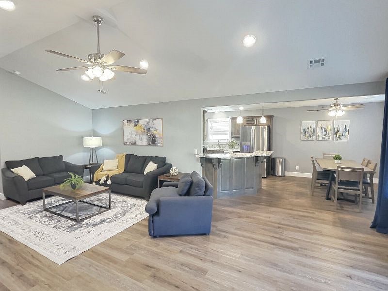 The living room, dining room and kitchen flow nicely together creating a welcoming and fun atmosphere for your family and friends.