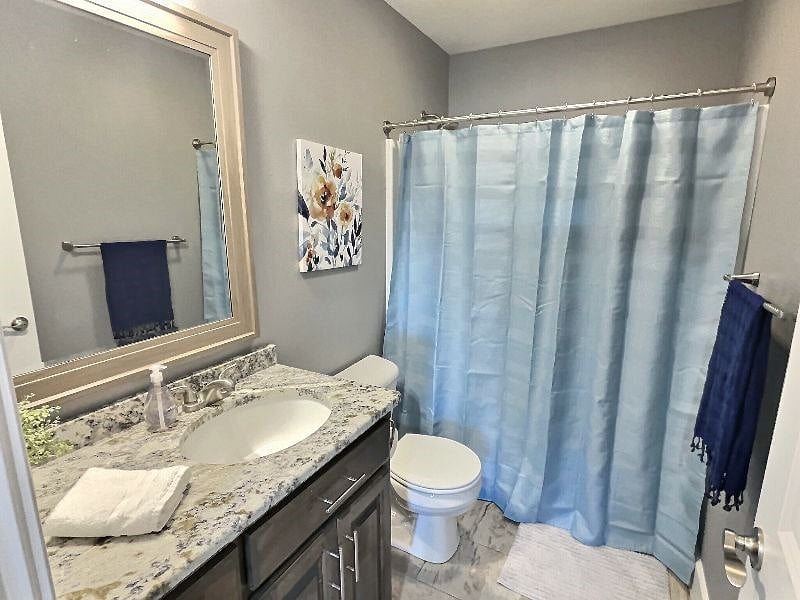 Full, spacious bathroom with granite vanity top.