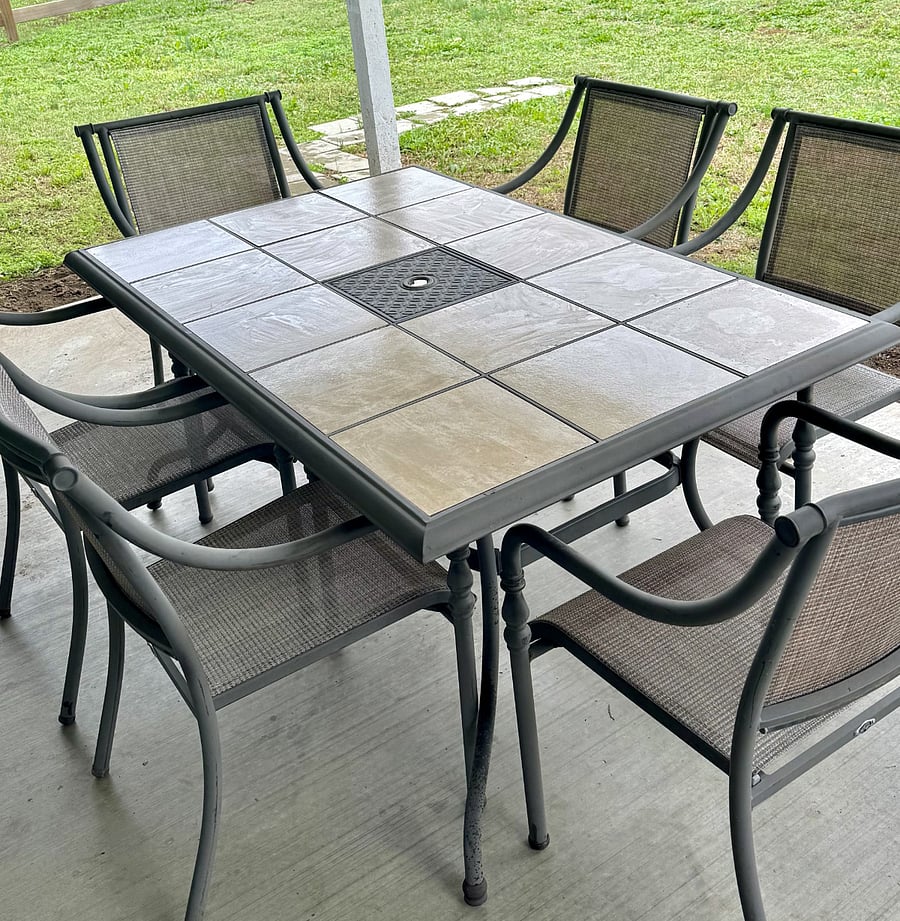 Covered Patio with spacious table and comfortable chairs to enjoy time in the outdoor space.
