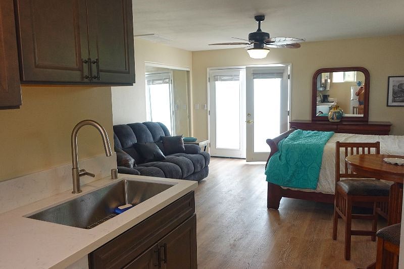 View of living areas and entry doors from kitchen