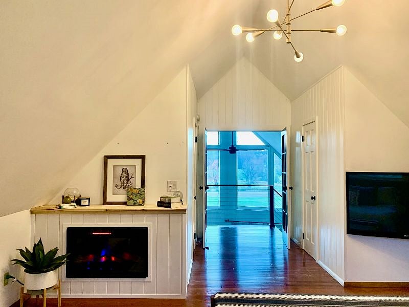 Electric fireplace in primary bedroom