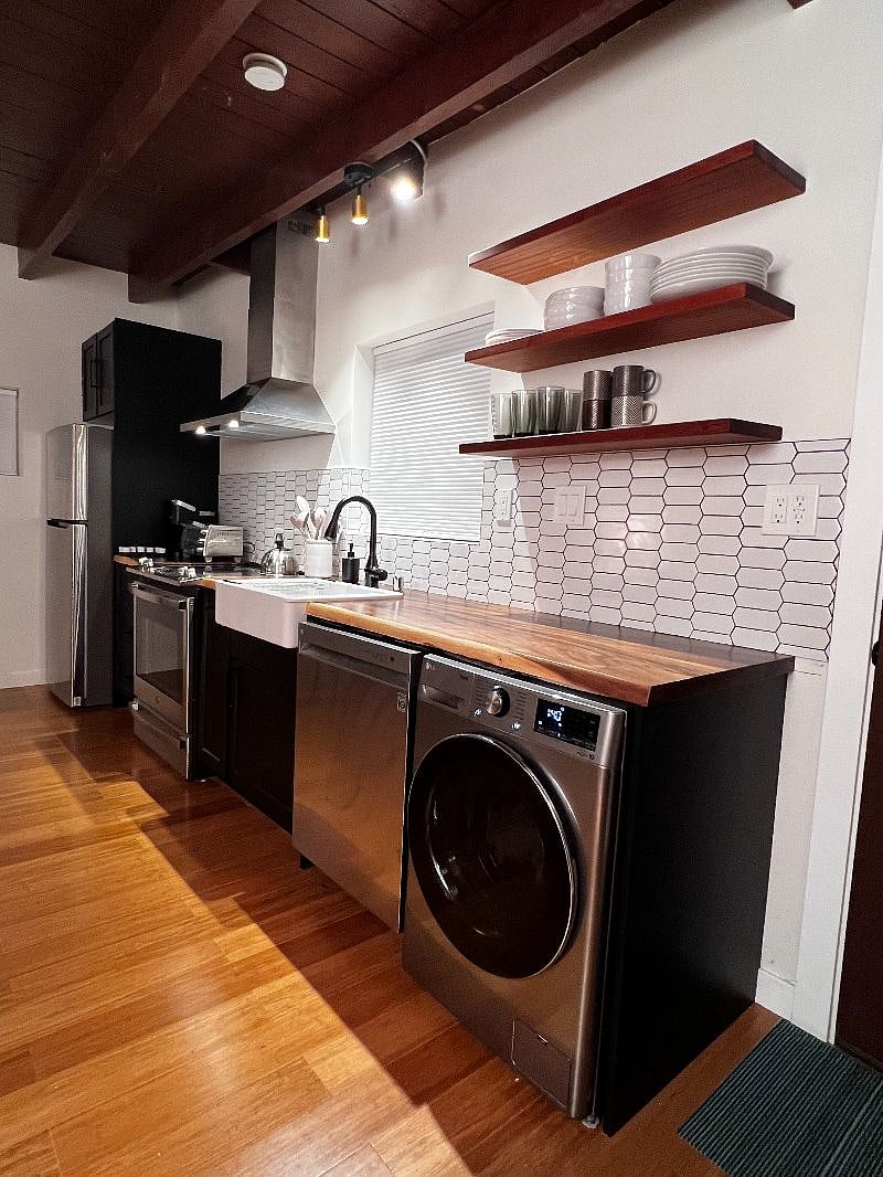 Kitchen with full size refrigerator, convection stove, Kurig coffee maker, dishwasher, all in one washer/dryer combo.