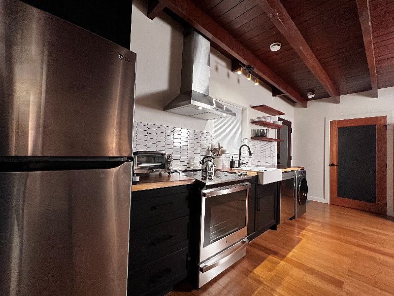Kitchen with full size refrigerator, convection stove, Kurig coffee maker, dishwasher, all in one washer/dryer combo.