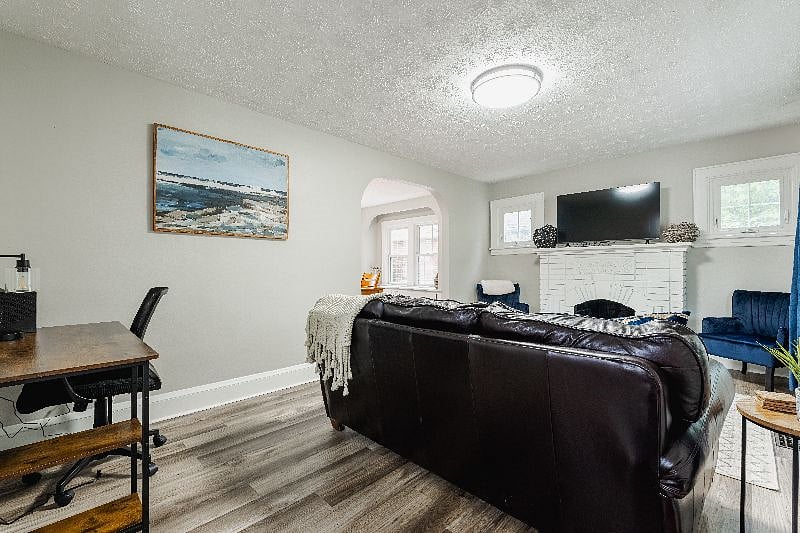 Living room with coach, chairs, workstation, smart TV, Roku