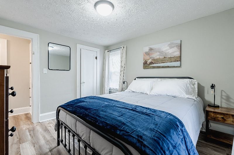 Master bedroom with queen bed, smart TV, Roku, dresser, night stands, closet