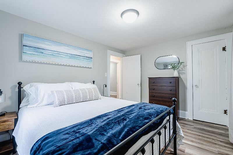 2nd bedroom with queen bed, closet, dresser, night stands