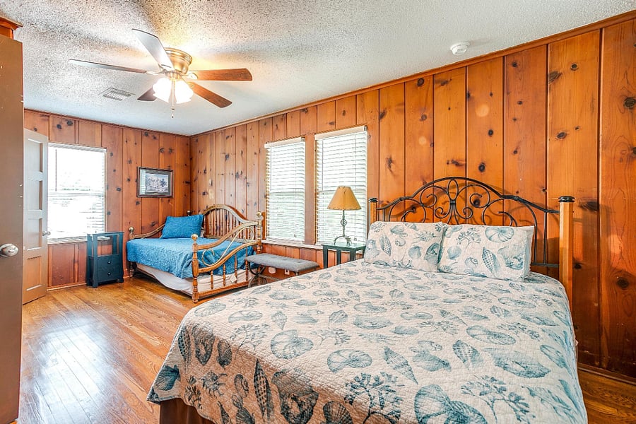 Bedroom with queen bed and single bed. Washer Dryer is in closet in the bedroom