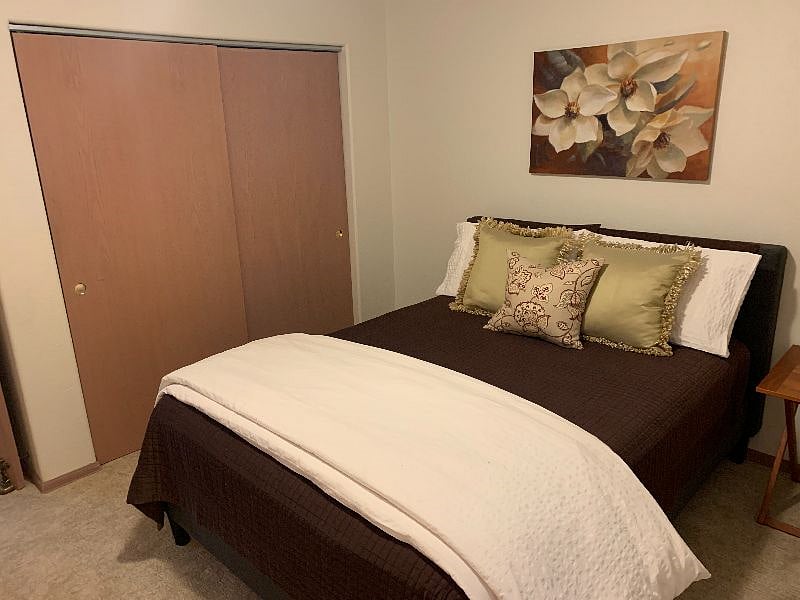 Bedroom with queen size bed with large closet.