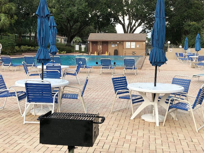 Pool deck with lounge chairs, tables & chairs, BBQ grills