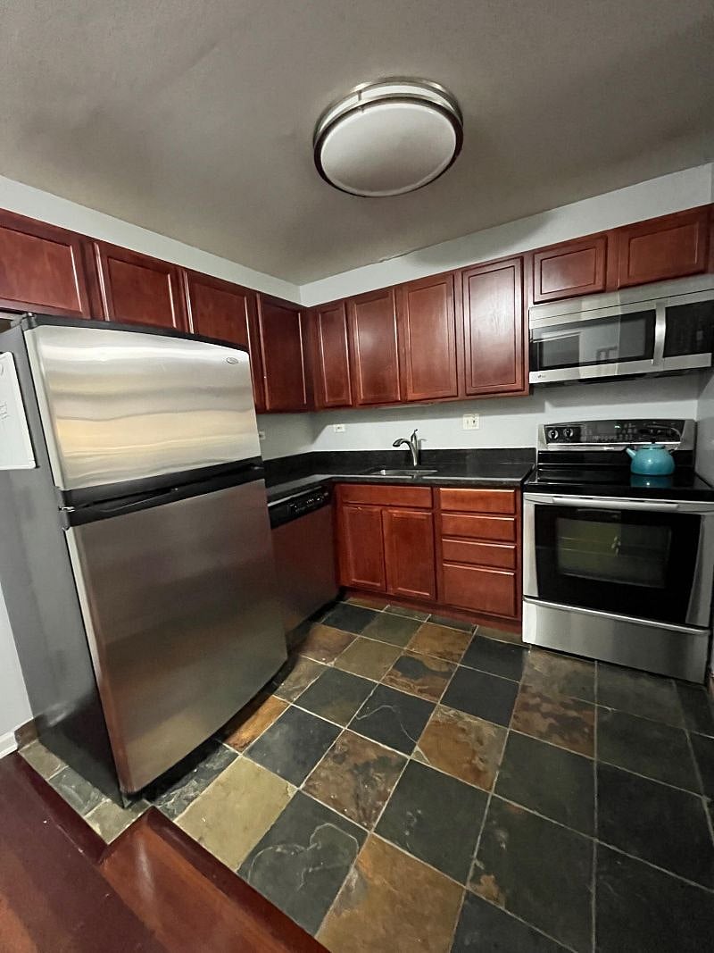 Kitchen fully stocked with dishes and appliances