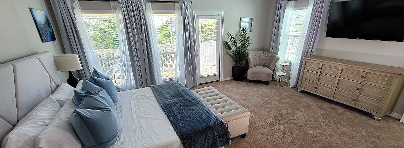 Door to 3rd floor balcony off of primary bedroom.
