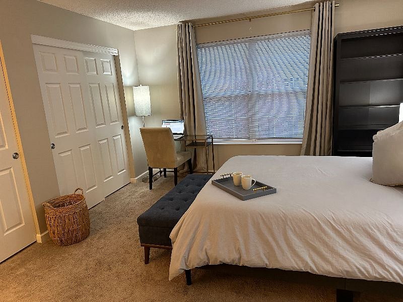 Master bedroom featuring a large double close, desk & chair, full dresser, large bookshelf, and side table on both sides of the bed with lamps. Master bath is private and in the Master bedroom.