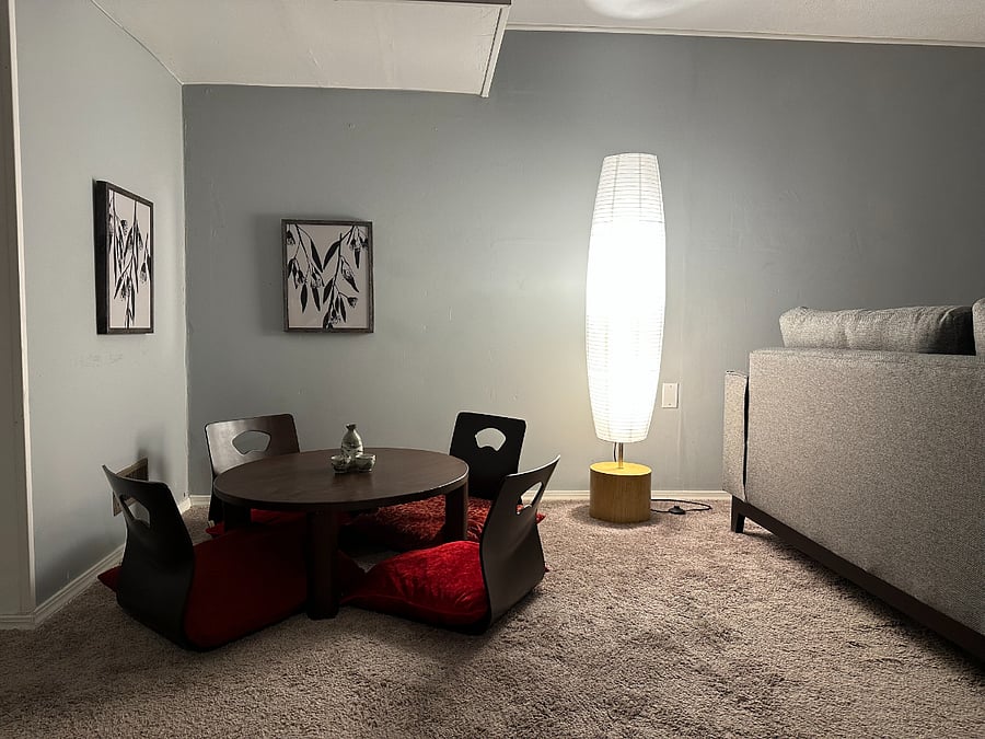 Lower level living area with sofa, mart TV and Japanese floor table.