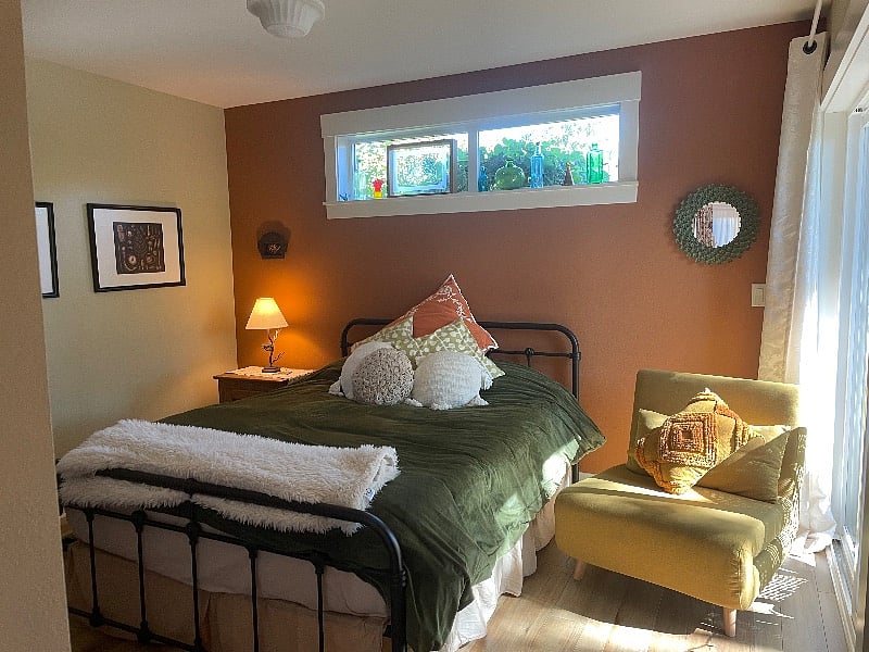 Main floor bedroom with Queen bed and slider door to garden space