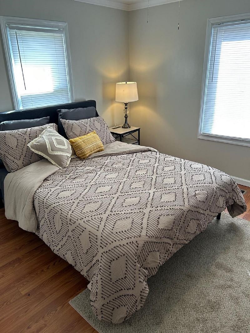 Bedroom with a queen sized bed, closet, chest of drawers, ceiling fan and a smart TV