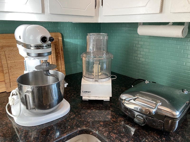 A few of the toys including Kitchen Aid Stand Mixer, Cuisinart 10-cup Food Processor, and All-Clad Pro Waffle Iron.