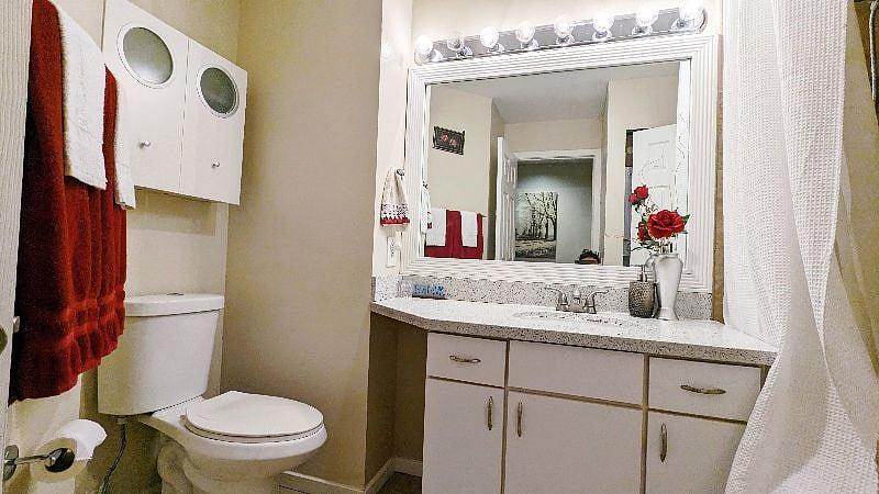 Full bathroom with washer and dryer