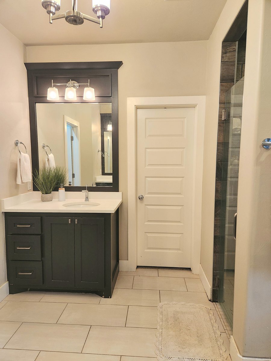 Bathroom for Room C. 2 sinks and enclosed toilet area.