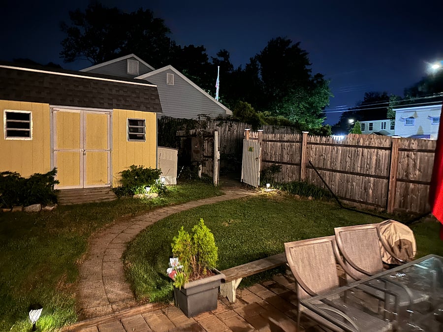 Backyard with hammock, gas grill, and firepit.