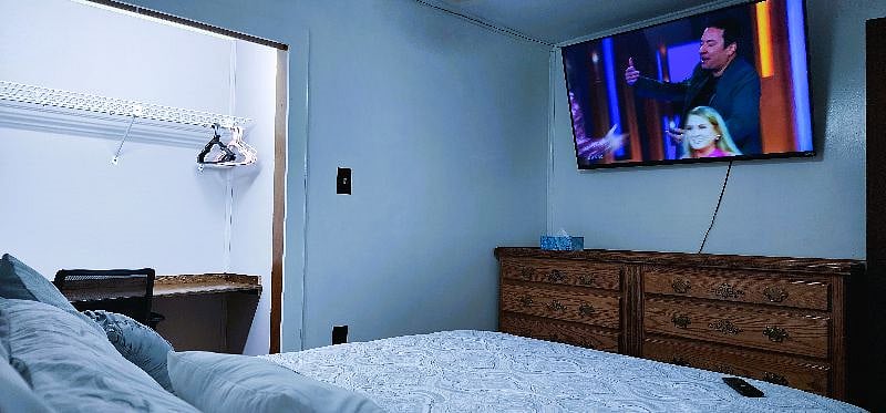 View from Wall of Bedroom 2 Full Size Bed with Led Lit headboard and 4 USB Charging Ports with traditional outlets. 10 drawer dresser. Closet can double as a workspace.