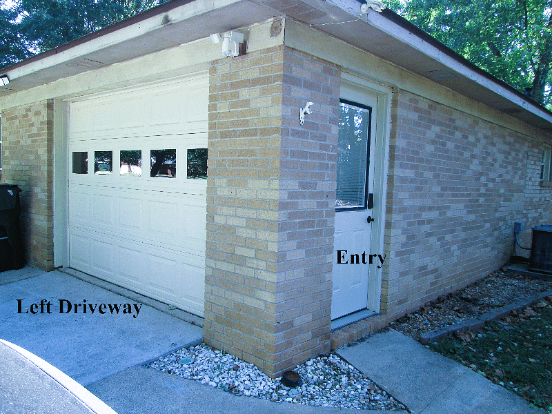 View from driveway - entry on side.  Driveway wide enough to easily park 2 vehicles.  Side entry has keypad and doorbell (no Camera)  Motion Sensing Lights above doors