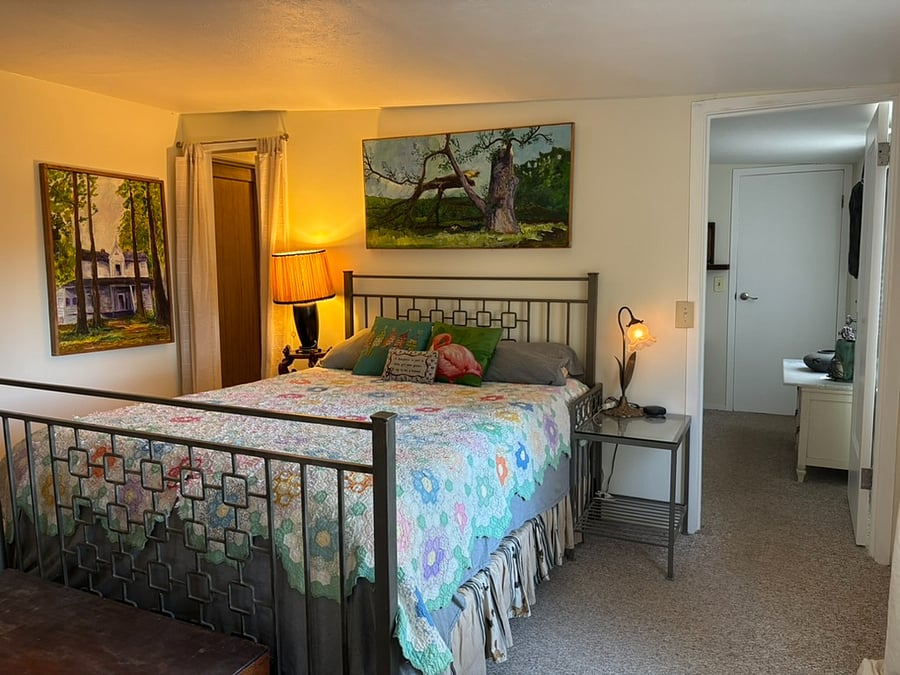 The Countryside Quarters room showing to the left the walk through closet and private passageway leading to the bathroom. One can enter this room from the Safari room or its own private entrance from the back deck