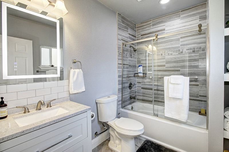 One of two private master bathrooms. Luxurious oversized LED mirror is touch-operated, fogless, dimmable, and provides warm, cool, or natural light.