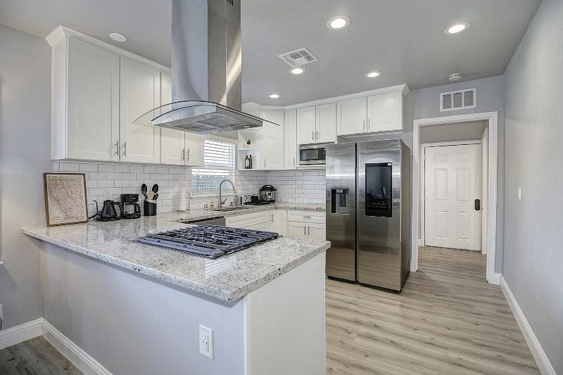 Wide granite counters wrap the kitchen. 