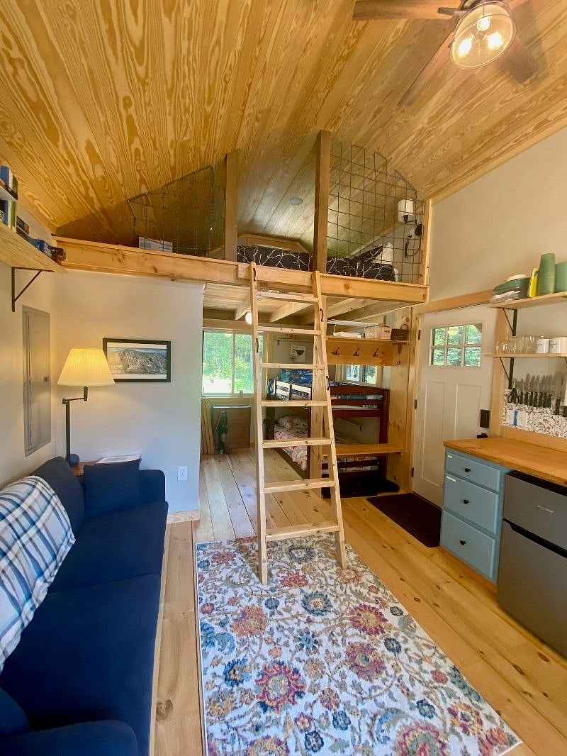 Main living area looking toward bunk nook, ladder and loft