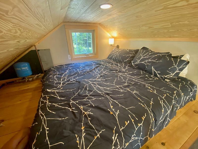 King-size bed in the loft, with reading lights on both sides of the bed.