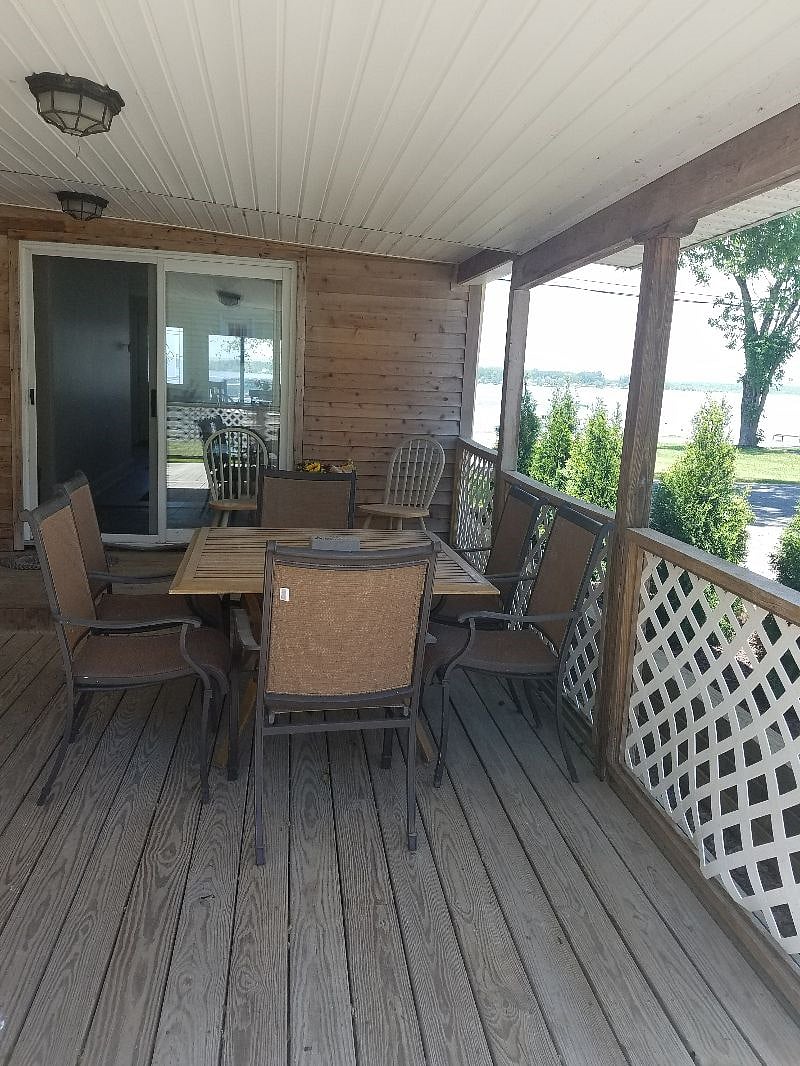 Large shaded back porch with view of Saratoga Lake and gardens. Tables and seating to accommodate 8 or more people. Gas grill.