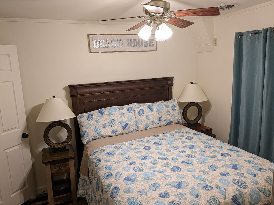 Third bedroom with queen bed, ceiling fan and walk-in closet.