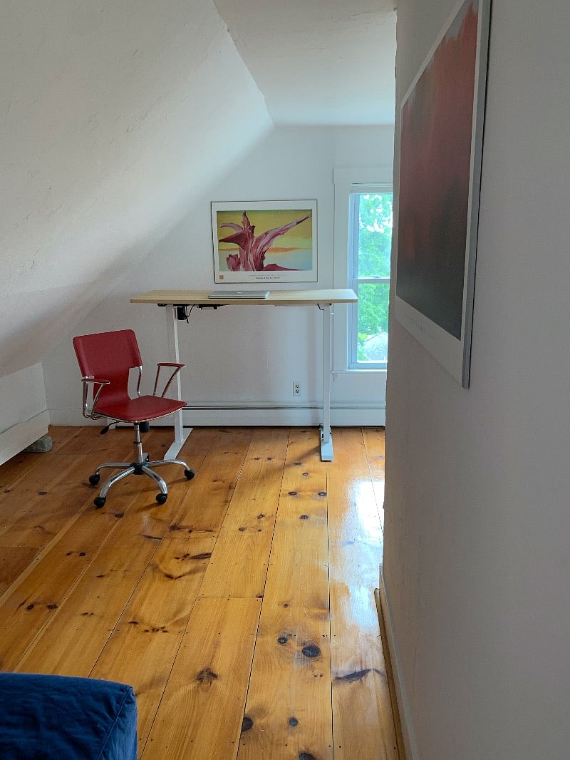 View of third floor from top of staircase toward work area of semi-divided penthouse. Sofa bed (double) to left.