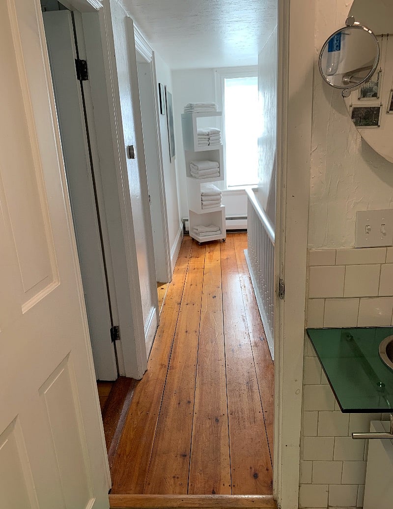 View from bathroom toward front of house; staircase to third floor around the corner.