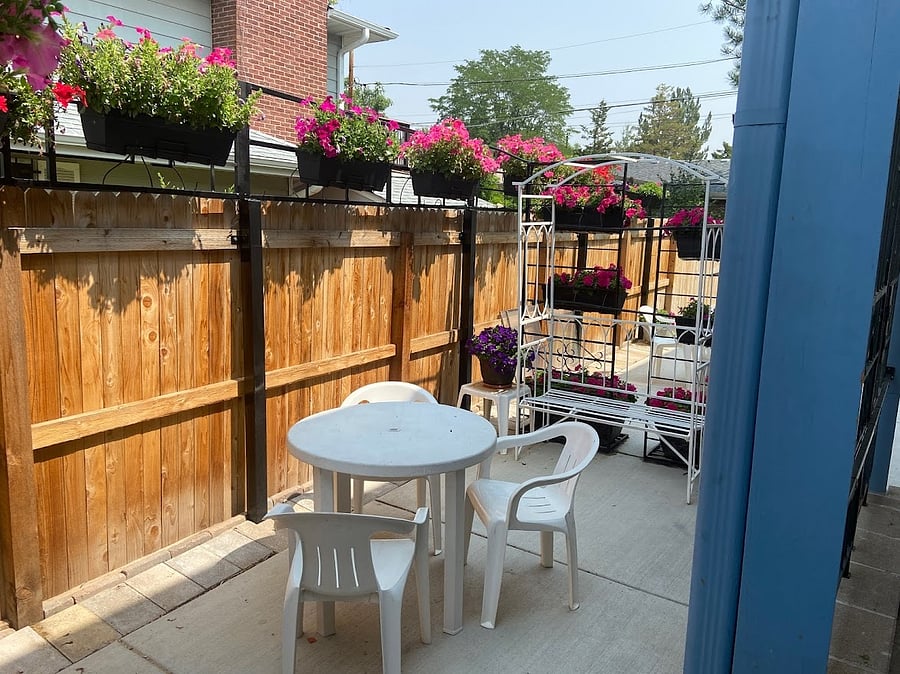 Private patio, about 10 x 15.  Summer flowers are lovely.  There's a table with four chairs plus the iron bench that seats two.  Beyond that bench is not part of the B&B patio.  In the winter there are, of course, no flowers, but there are lights.