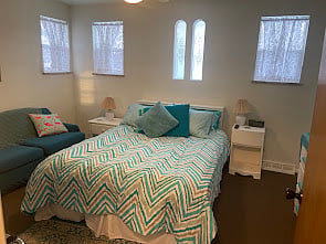 Bedroom 1.  12 x 14.  Queen-sized bed, night stands, loveseat, clothes hanging bar, dresser, full-length mirror, attached bath with shower.