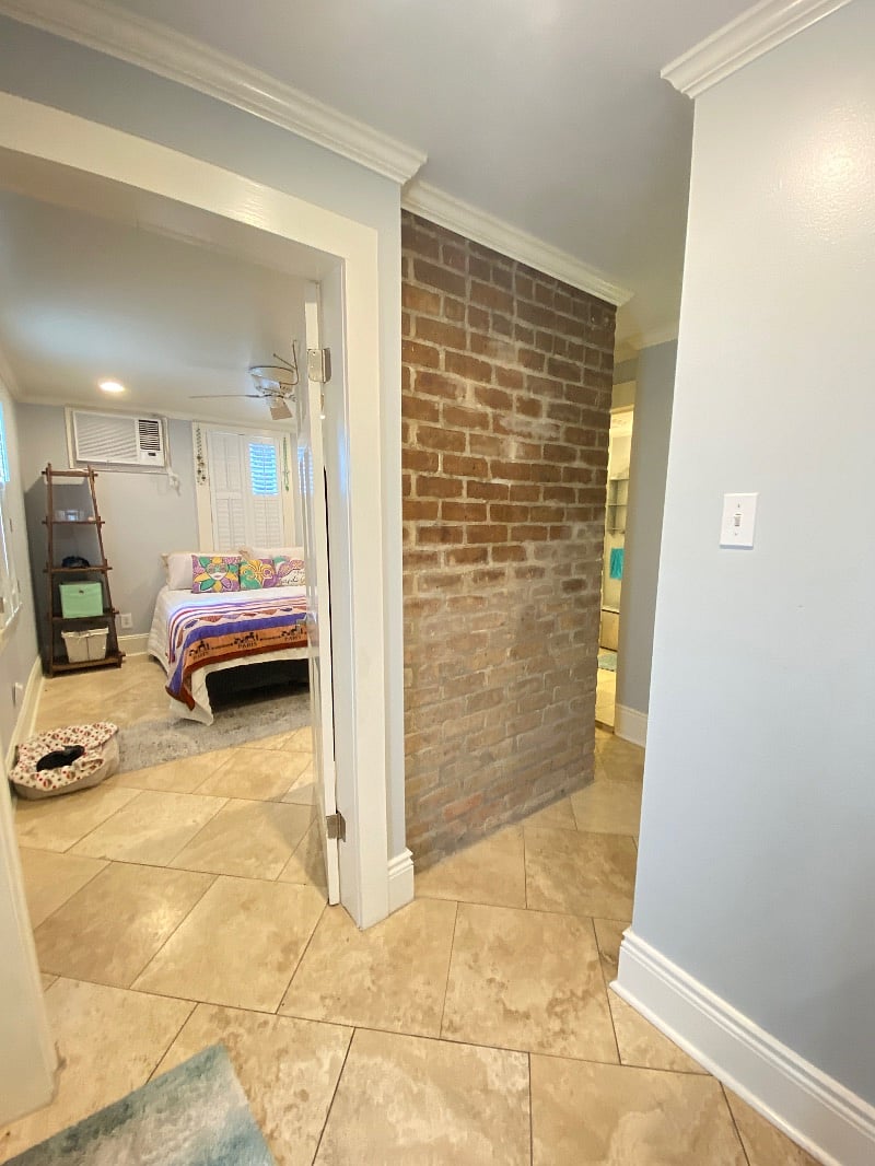 View of bedroom and hall leading to 2nd bathroom entrance.
