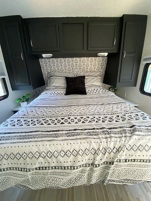 queen bed with black out blinds and privacy curtain