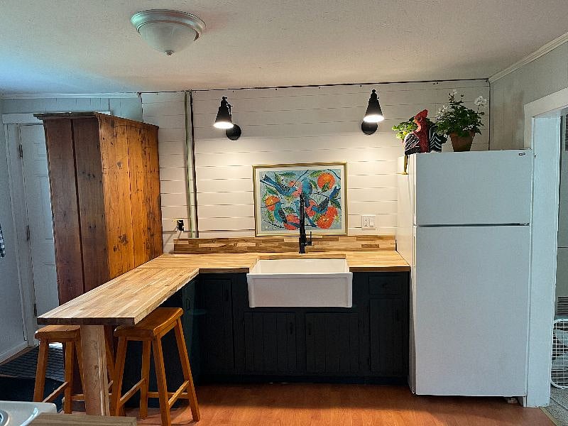 Kitchen with main cottage entrance (on left of antique wooden closet)
